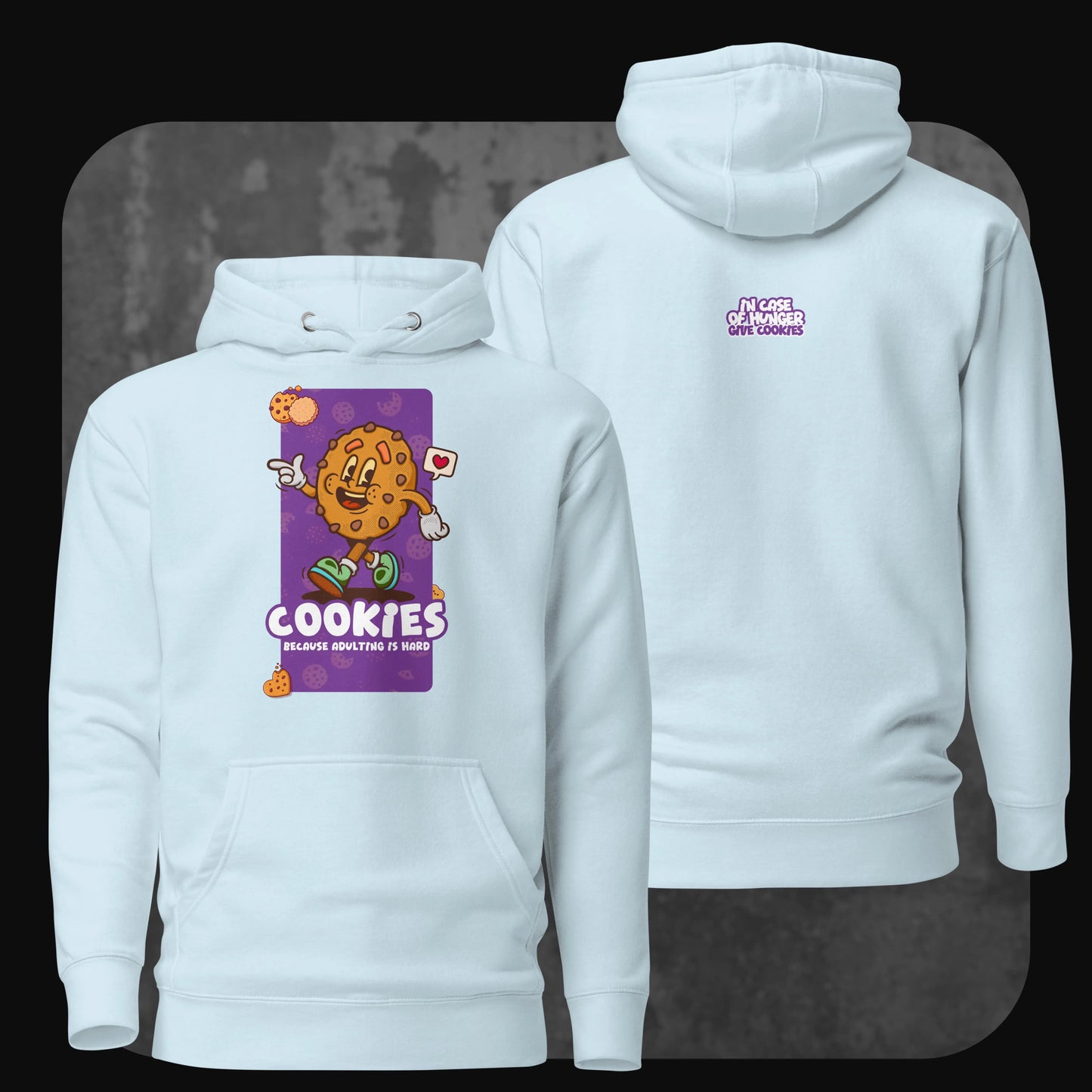 A soft light blue hoodie featuring a lively cookie illustration on the front with “Cookies because adulting is hard” text. On the back, the phrase “In case of hunger, give cookies” is written in a matching playful font.