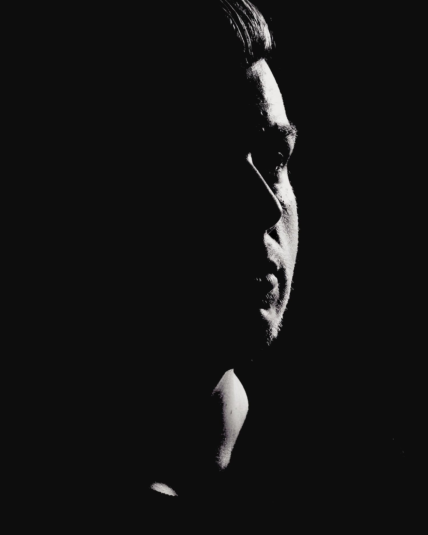 A portrait of the founder of rodneylogan, who is seen half in shadows.