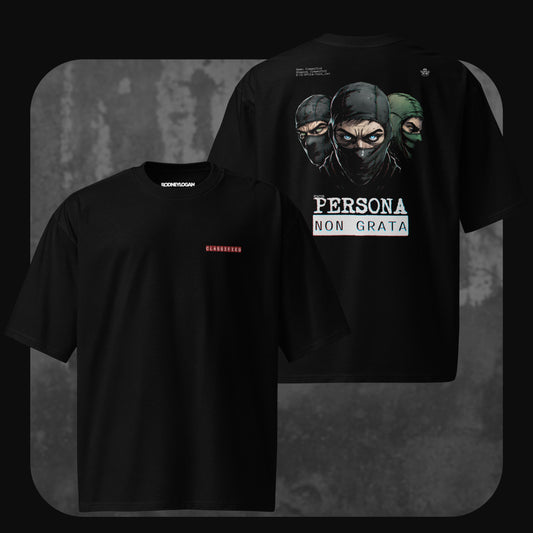 Black oversized t-shirt with “CLASSIFIED” text on the front chest in red, and a large back graphic of three masked figures above the phrase “PERSONA NON GRATA” in bold white letters.