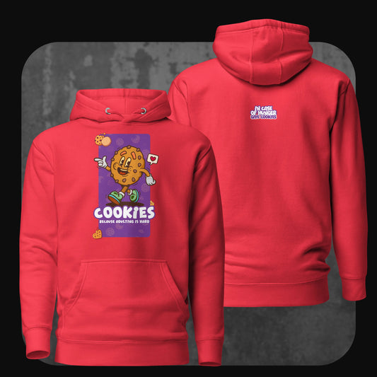 A vibrant red hoodie with a smiling cartoon cookie on the front, captioned “Cookies because adulting is hard.” The back shows the text “In case of hunger, give cookies” in bold purple.