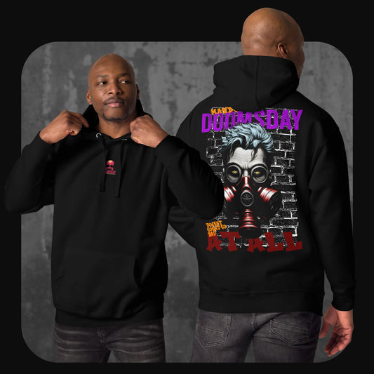 A man models a black hoodie with a red skull and text logo on the front chest and a large graphic on the back showing a man with blue hair wearing a red gas mask in front of a brick wall.