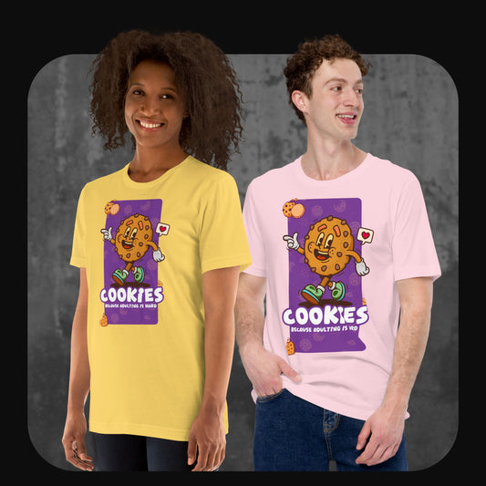 Two models wearing graphic t-shirts with a cartoon cookie character and the phrase “Cookies – Because adulting is hard.” One wears yellow, the other pink.