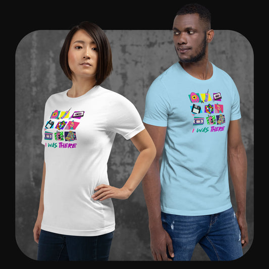 A woman in a white shirt and a man in a sky-blue shirt, both wearing “I WAS THERE” t-shirts showcasing vibrant retro tech illustrations and bold neon text.