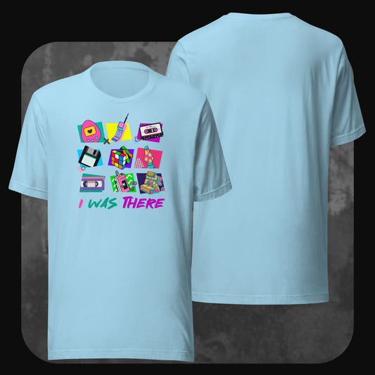 Sky-blue t-shirt with a front graphic of vintage technology and pop culture items in bright neon colors, captioned with “I WAS THERE”.